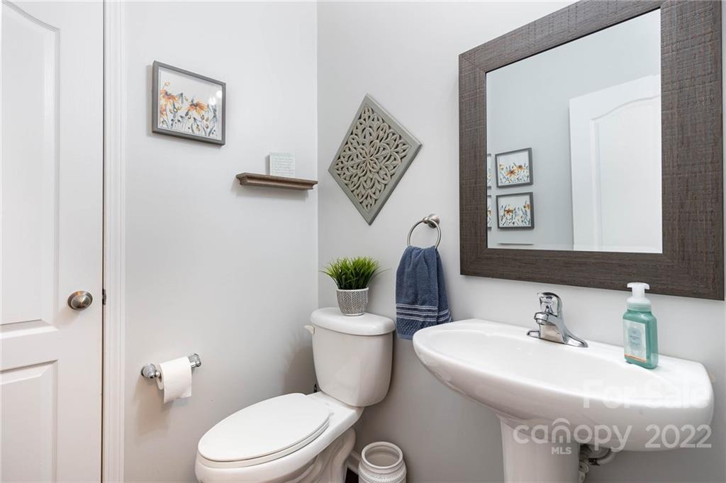 1563 Spring Blossom Trail Fort Mill, SC 29708 - Photo 9 of 25 a bathroom with a toilet sink and mirror