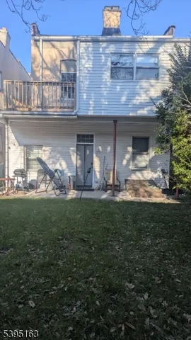 a view of a house with a yard and a fountain