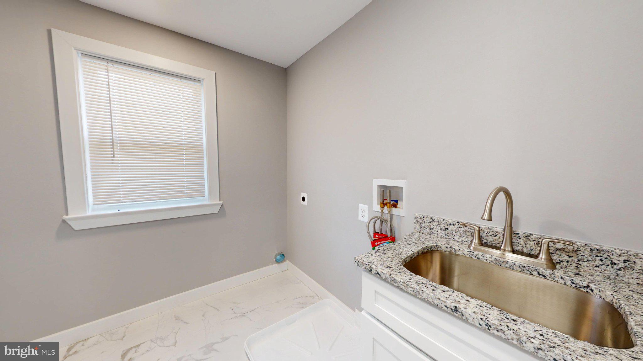 5728 Clover Road Baltimore, MD 21215 - Photo 19 of 37 Bright and airy laundry space.