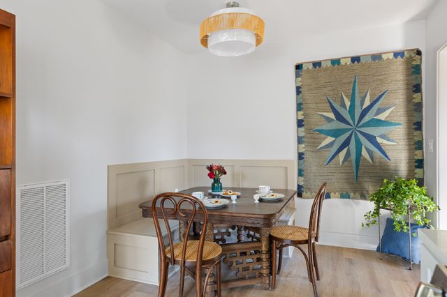 a view of a dining room with furniture and wooden floor