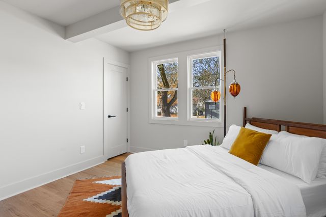 a bedroom with a bed and painting on the wall
