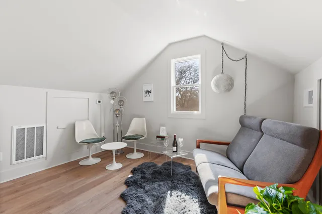 a living room with furniture a rug and a window