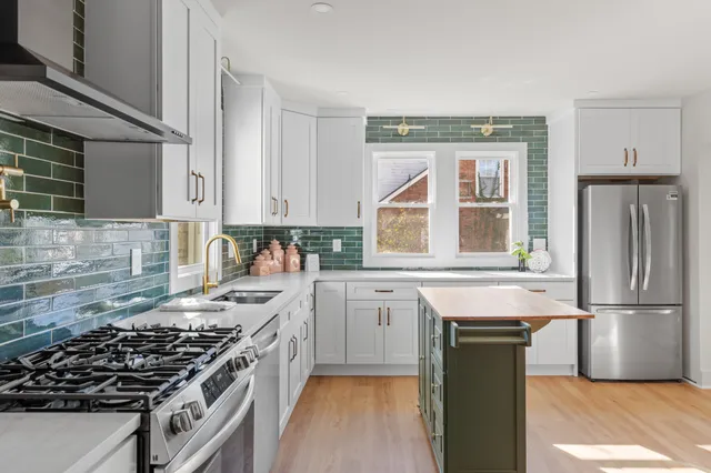 a kitchen with a stove a sink and a refrigerator
