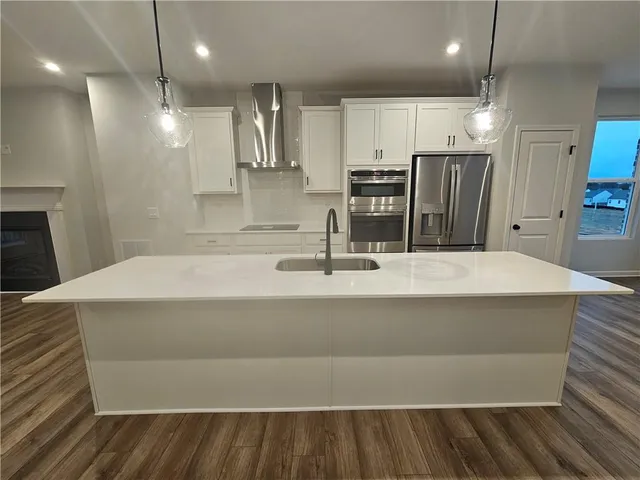 a bathroom with a sink a large mirror and a vanity