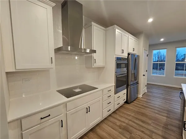 a kitchen with stainless steel appliances a refrigerator and cabinets