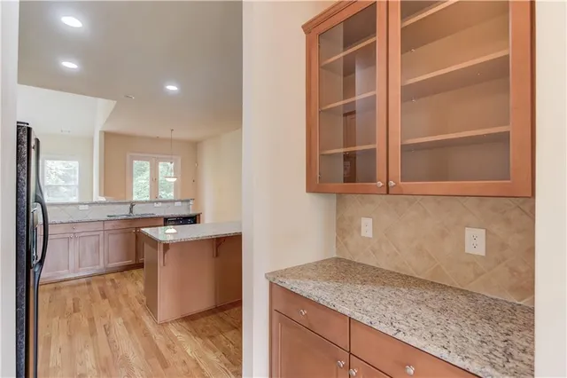 a kitchen with stainless steel appliances granite countertop a sink stove and cabinets