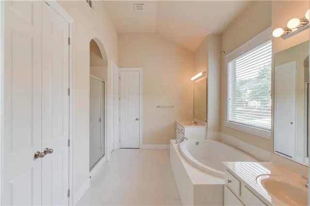 a bathroom with a granite countertop sink a toilet and shower