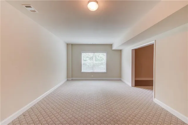 an empty room with windows and closet