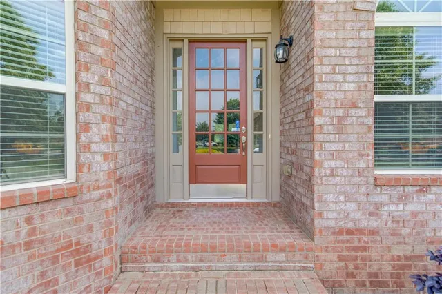 a view of a brick house with large windows
