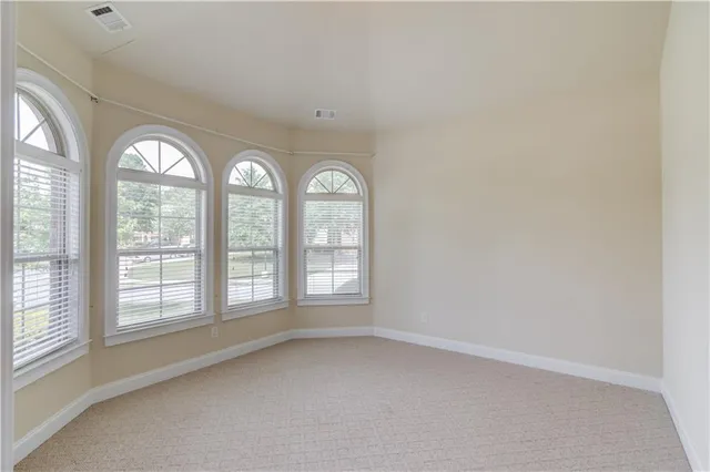 an empty room with a empty space and windows