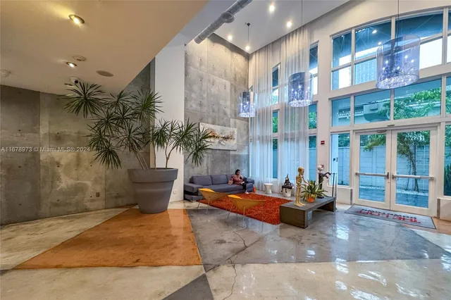 a living room with furniture wooden floor and a flat screen tv