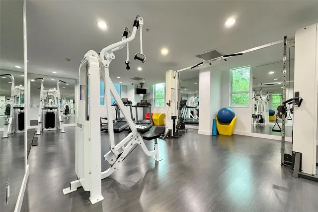a room with gym equipment and a large window