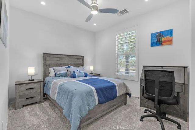 a bed room with a bed and a chair