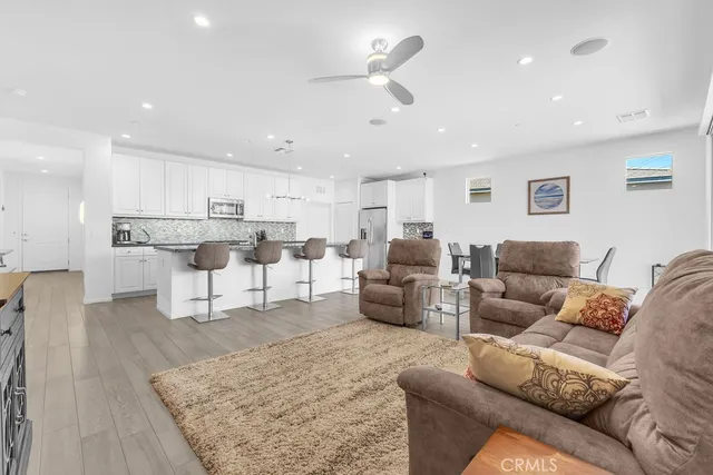 a living room with furniture and kitchen view
