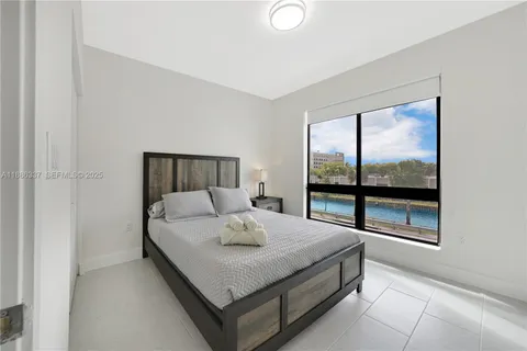 a kitchen with stainless steel appliances granite countertop white cabinets a stove top oven a sink and dishwasher