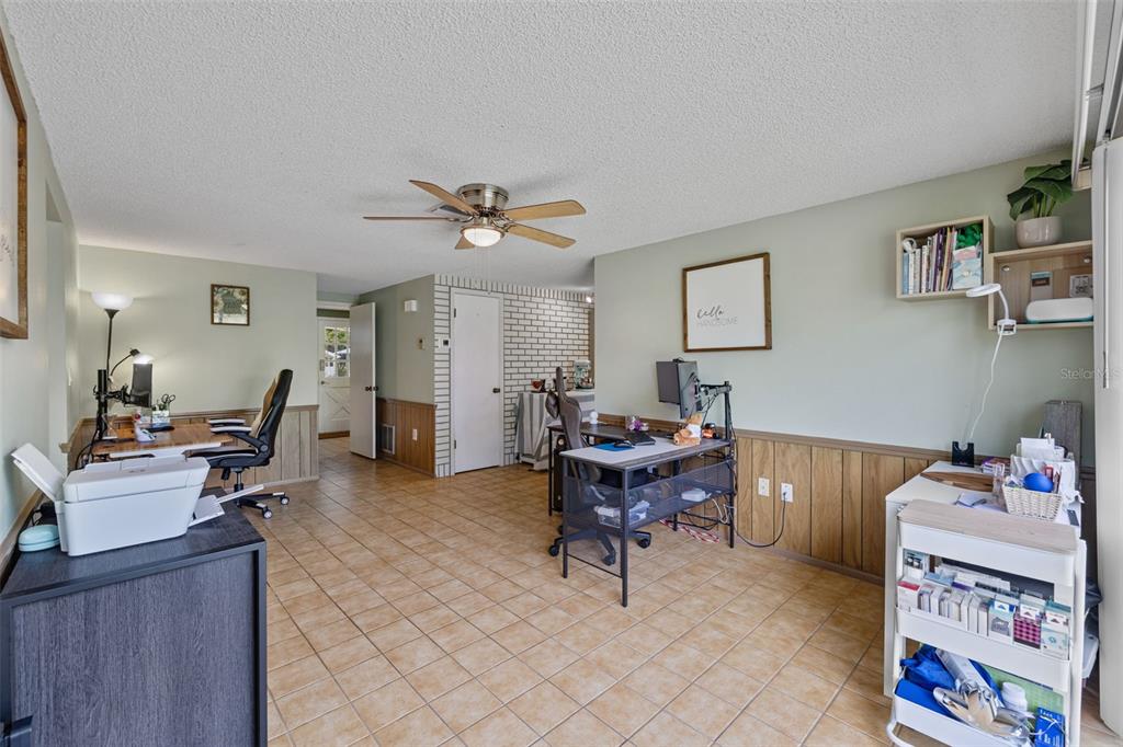 12111 Fieldstone Lane Hudson, FL 34667 - Photo 16 of 49 a living room with furniture and a dining table with bookshelf