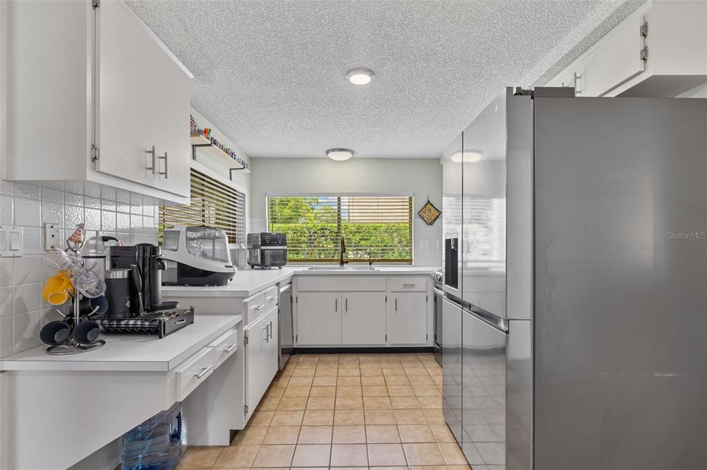 12111 Fieldstone Lane Hudson, FL 34667 - Photo 17 of 49 a kitchen that has a lot of cabinets in it and appliances