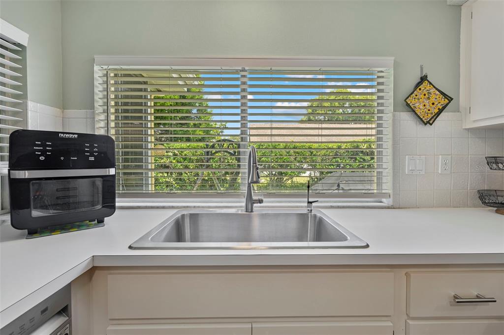 12111 Fieldstone Lane Hudson, FL 34667 - Photo 19 of 49 a view of a kitchen sink a stove and a window