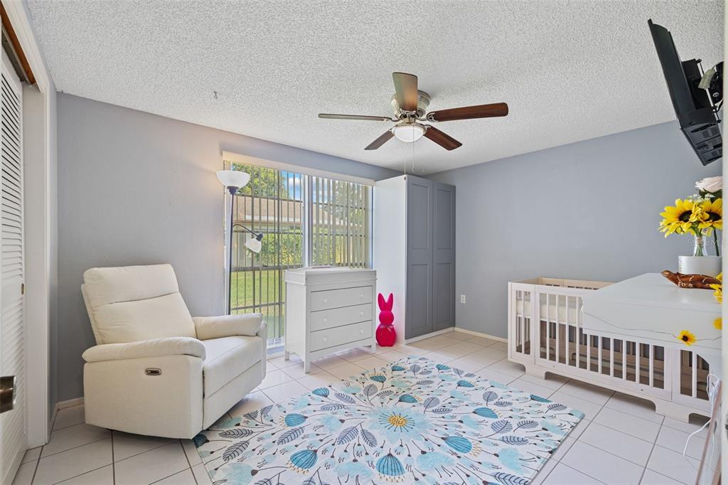 12111 Fieldstone Lane Hudson, FL 34667 - Photo 21 of 49 a bed room with furniture and wooden floor