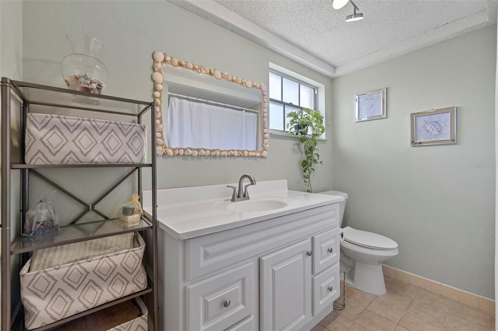 12111 Fieldstone Lane Hudson, FL 34667 - Photo 24 of 49 a bathroom with a sink toilet and vanity