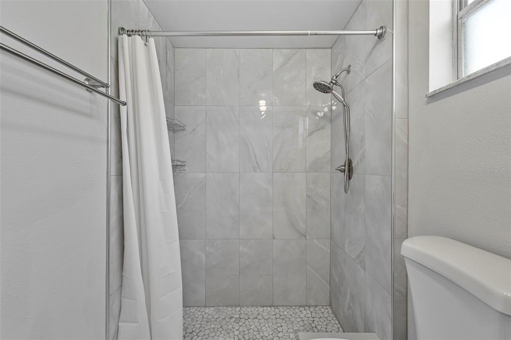 12111 Fieldstone Lane Hudson, FL 34667 - Photo 26 of 49 a bathroom with a shower