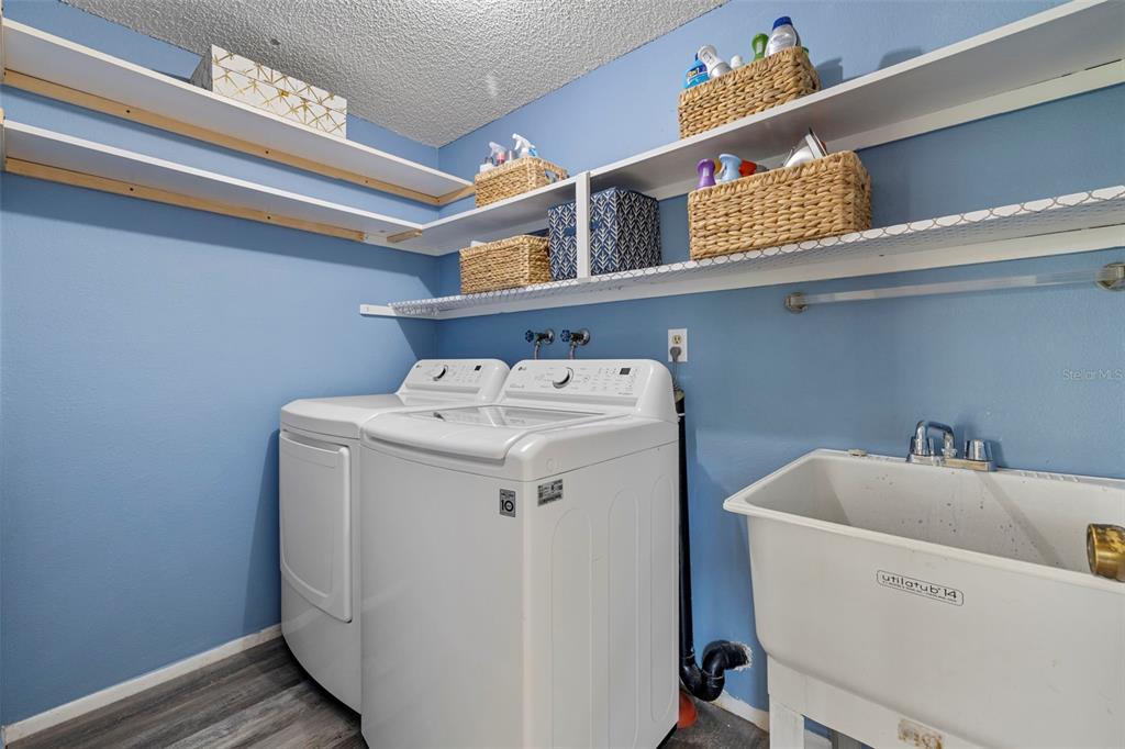 12111 Fieldstone Lane Hudson, FL 34667 - Photo 28 of 49 a utility room with dryer and washer