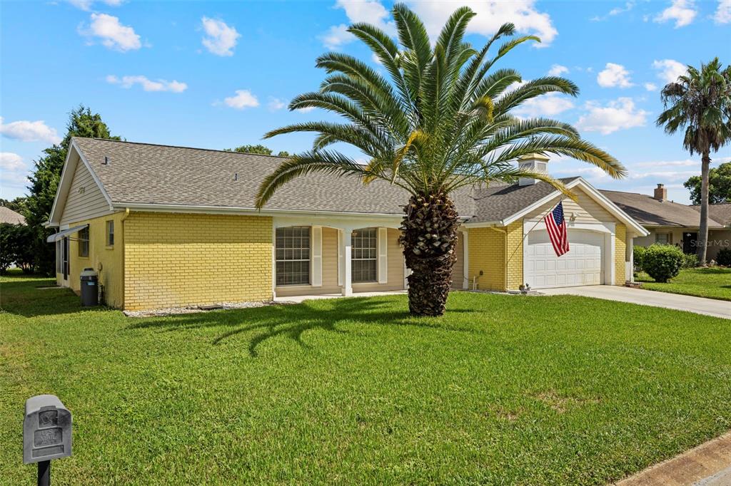 12111 Fieldstone Lane Hudson, FL 34667 - Photo 32 of 49 a house view with a garden space