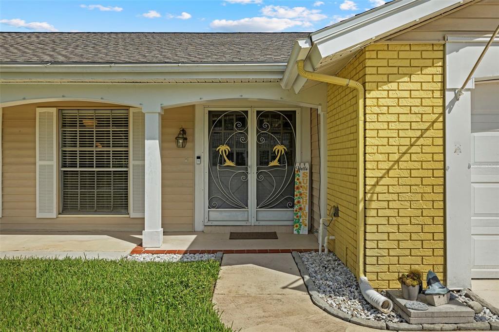12111 Fieldstone Lane Hudson, FL 34667 - Photo 33 of 49 a front view of a house with a yard