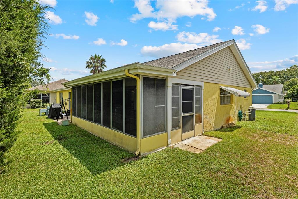 12111 Fieldstone Lane Hudson, FL 34667 - Photo 35 of 49 a view of a house with backyard and porch