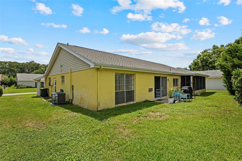 12111 Fieldstone Lane Hudson, FL 34667 - Photo 36 of 49 a view of a house with backyard porch and sitting area