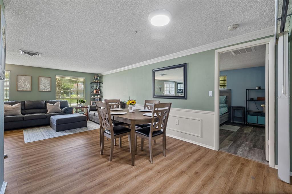 12111 Fieldstone Lane Hudson, FL 34667 - Photo 6 of 49 a view of a dining room with furniture and wooden floor