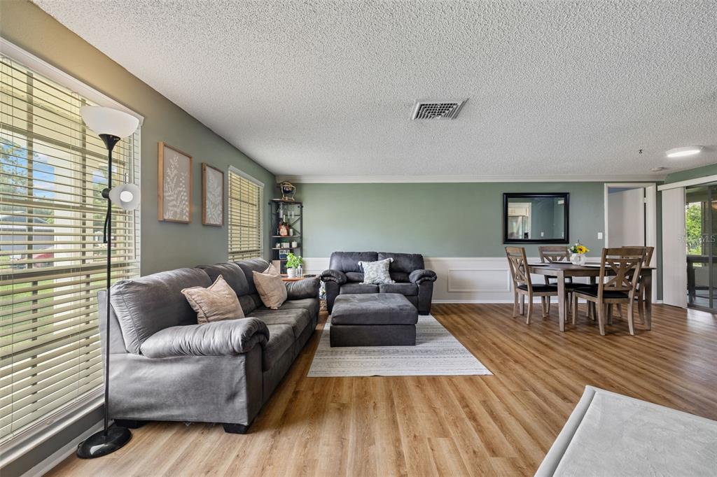 12111 Fieldstone Lane Hudson, FL 34667 - Photo 8 of 49 a living room with furniture and a wooden floor