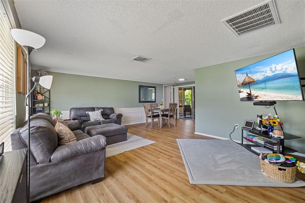 12111 Fieldstone Lane Hudson, FL 34667 - Photo 10 of 49 a living room with furniture and wooden floor