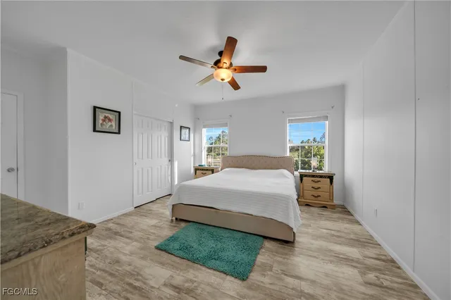 a spacious bedroom with a bed and a chandelier