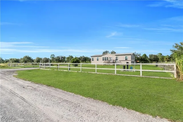 a view of a house with a yard and sitting area