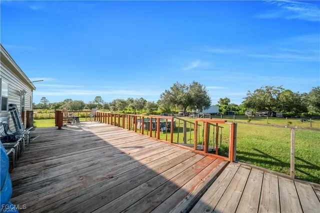 a view of balcony and deck with wooden floor and fence