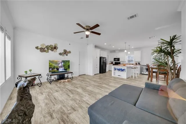 a large kitchen with a table and refrigerator