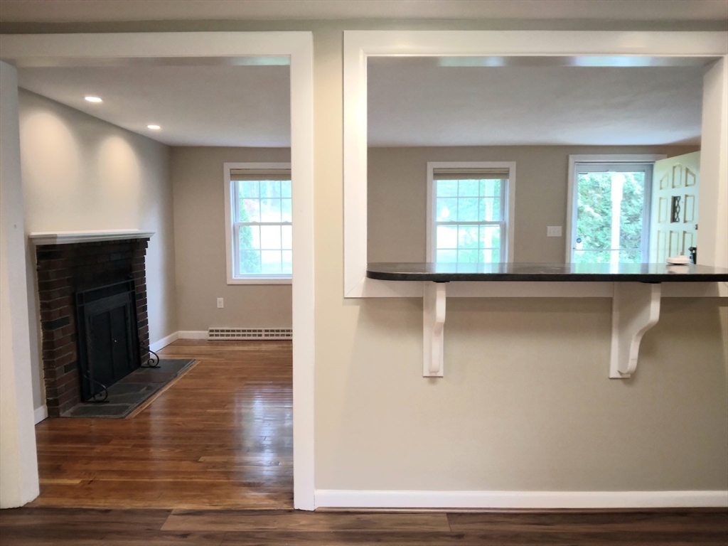 42 Lowell Road Pepperell, MA 01463 - Photo 11 of 32 a view of an empty room with wooden floor and a window