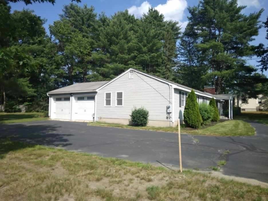 42 Lowell Road Pepperell, MA 01463 - Photo 2 of 32 a view of a house with a yard and large tree