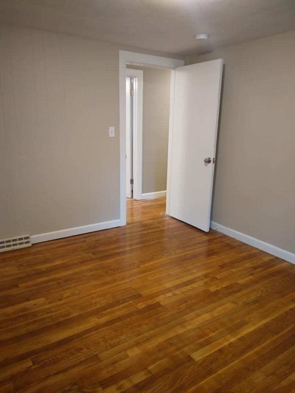 42 Lowell Road Pepperell, MA 01463 - Photo 21 of 32 a view of an empty room with wooden floor