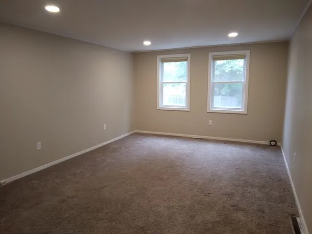 a bathroom with a shower a toilet and a shower