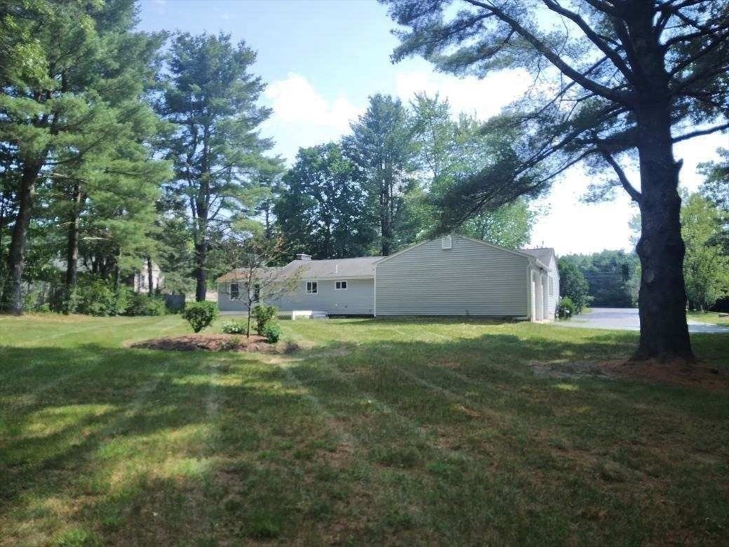 42 Lowell Road Pepperell, MA 01463 - Photo 3 of 32 a backyard of a house with lots of green space