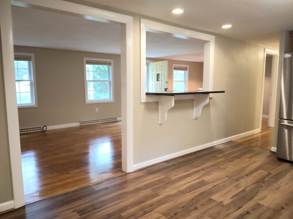 42 Lowell Road Pepperell, MA 01463 - Photo 10 of 32 an empty room with wooden floor and windows