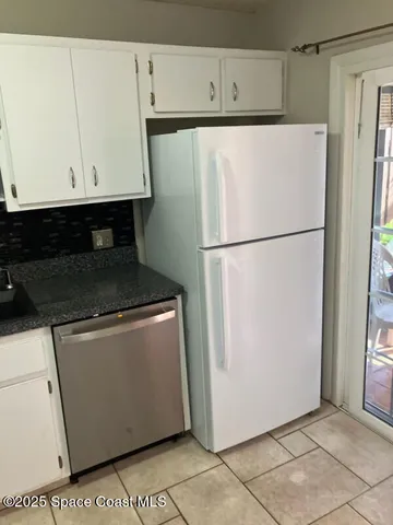 a white refrigerator freezer sitting in a kitchen