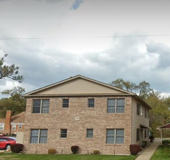 2310 West 5th Avenue, Unit A Gary, IN 46404 - Photo 1 of 4 a front view of a house with a yard