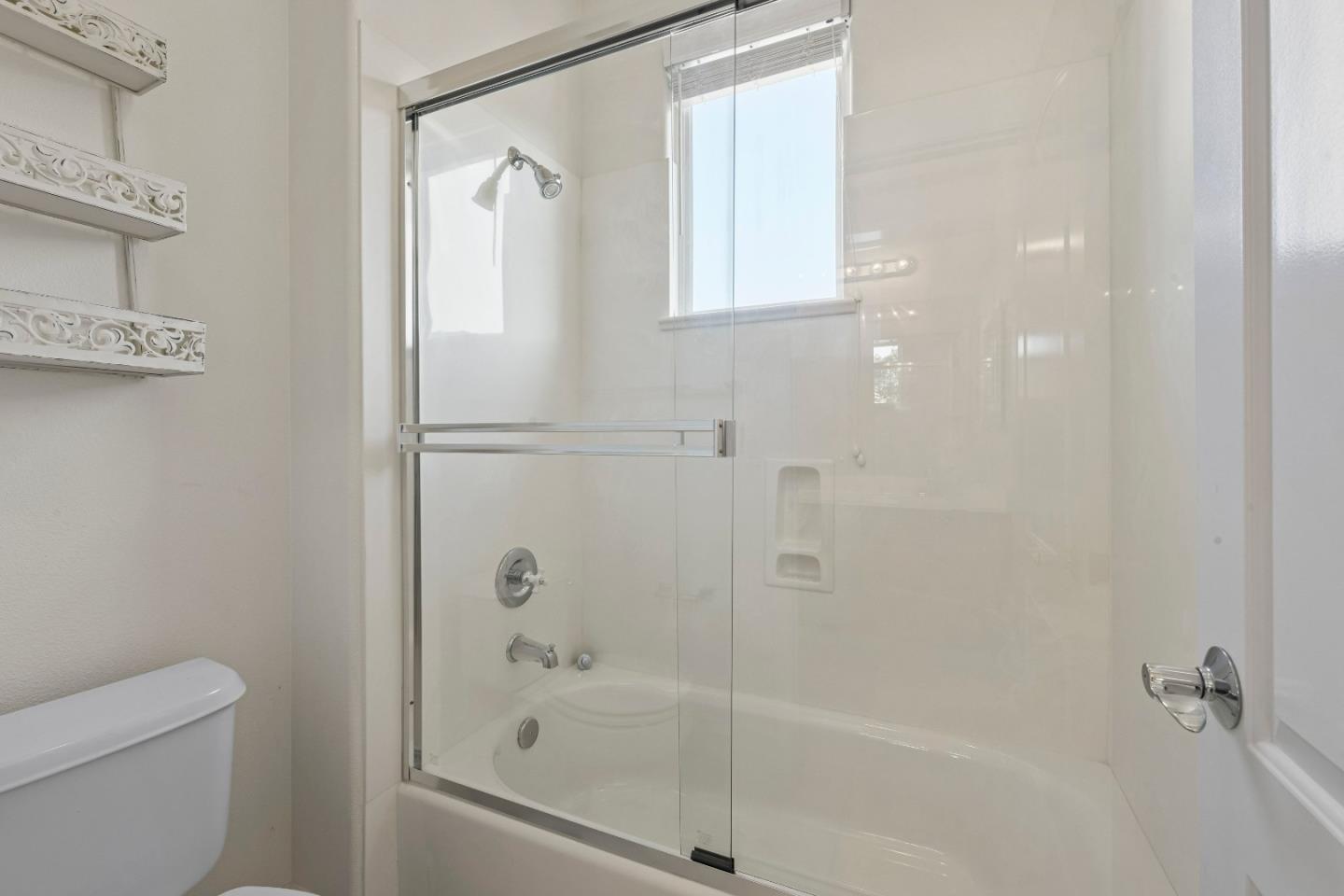 7466 Dunbar Court Gilroy, CA 95020 - Photo 67 of 103 a bathroom with a shower a toilet and a window