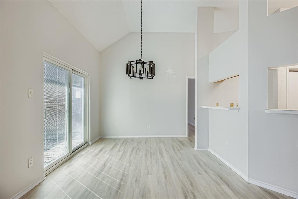 4319 Harvest Hill Road Carrollton, TX 75010 - Photo 11 of 28 Unfurnished dining area featuring light wood finished floors, high vaulted ceiling, and a chandelier