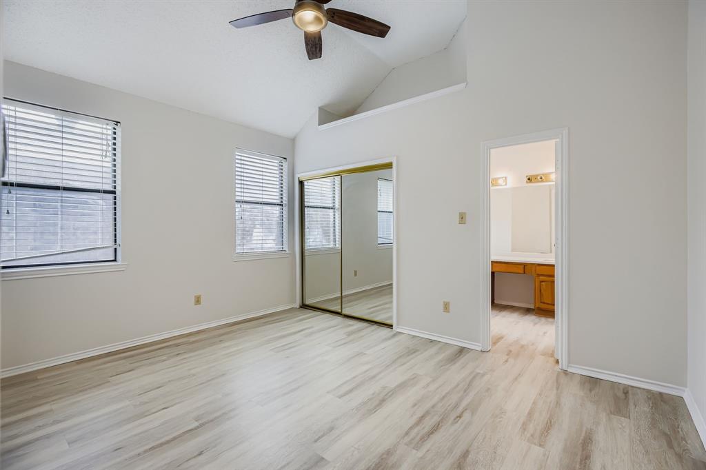 4319 Harvest Hill Road Carrollton, TX 75010 - Photo 16 of 28 Unfurnished bedroom with light wood-style flooring, an office area, a ceiling fan, a closet, and high vaulted ceiling