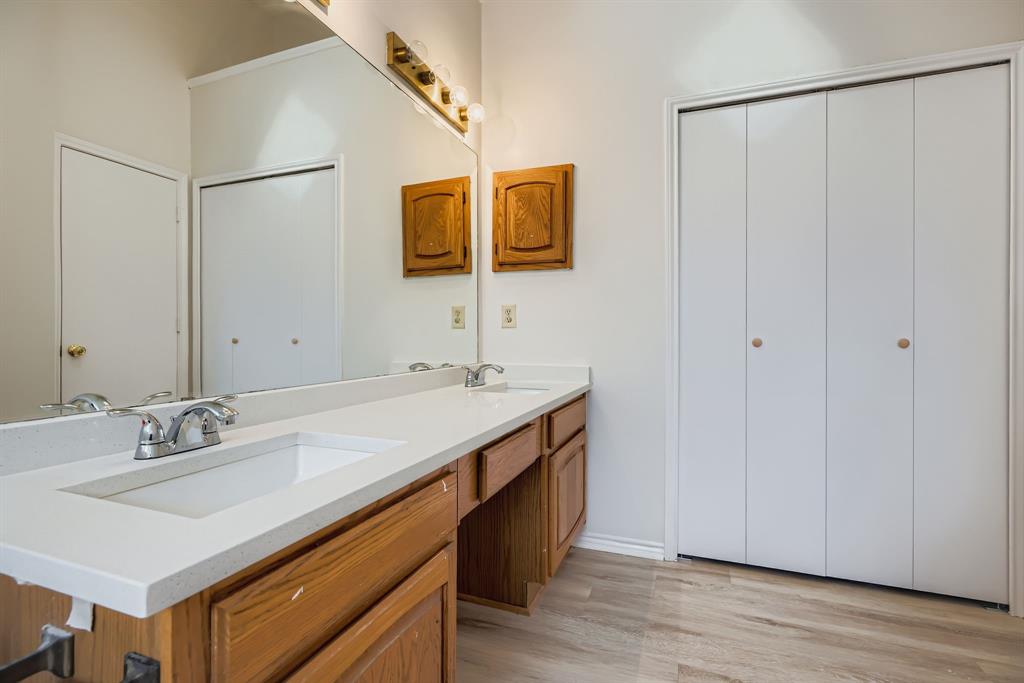 4319 Harvest Hill Road Carrollton, TX 75010 - Photo 19 of 28 Bathroom with double vanity and light wood-style floors