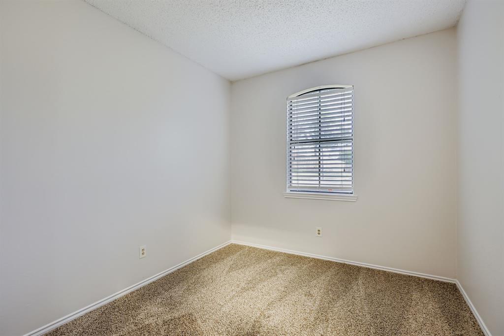 4319 Harvest Hill Road Carrollton, TX 75010 - Photo 20 of 28 Empty room featuring carpet and a textured ceiling